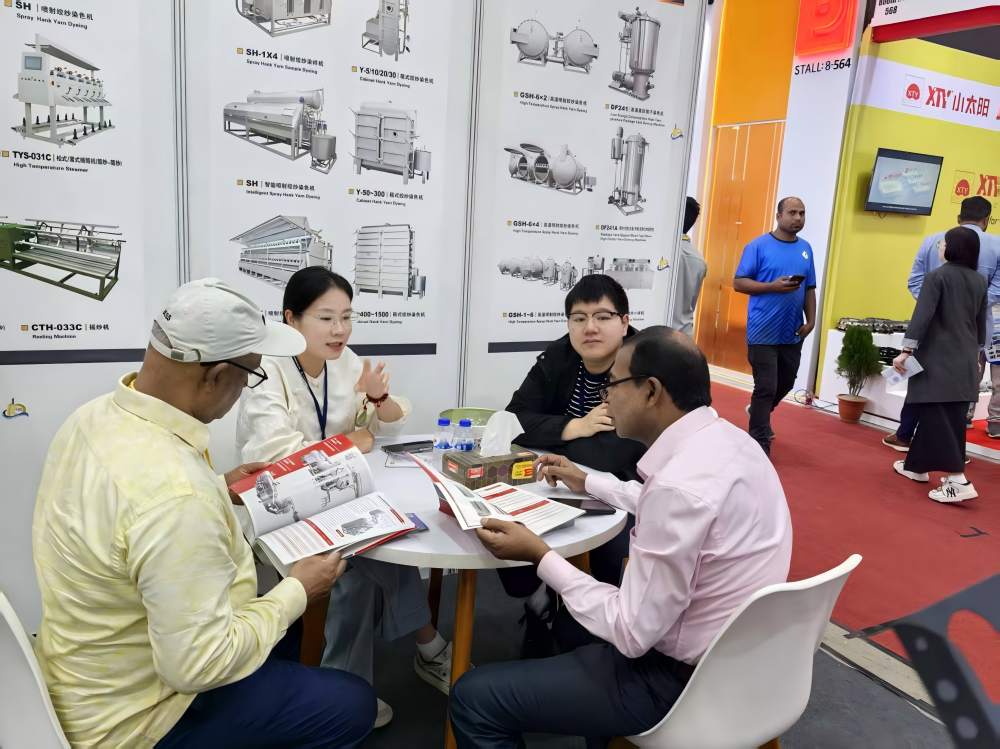Discussion with visitors about dyeing machine applications at DTG Bangladesh 2025