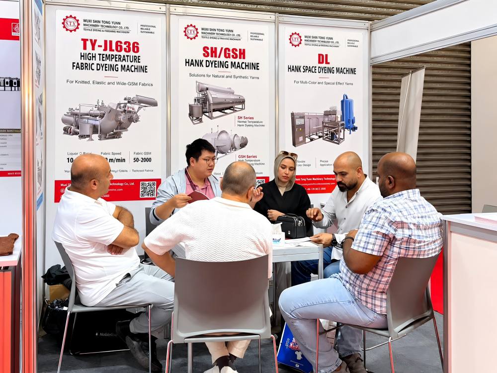 Customer Discussion at Shin Tong Yunn Booth 5E9 Visitors discussing textile dyeing machinery at Shin Tong Yunn Booth 5E9