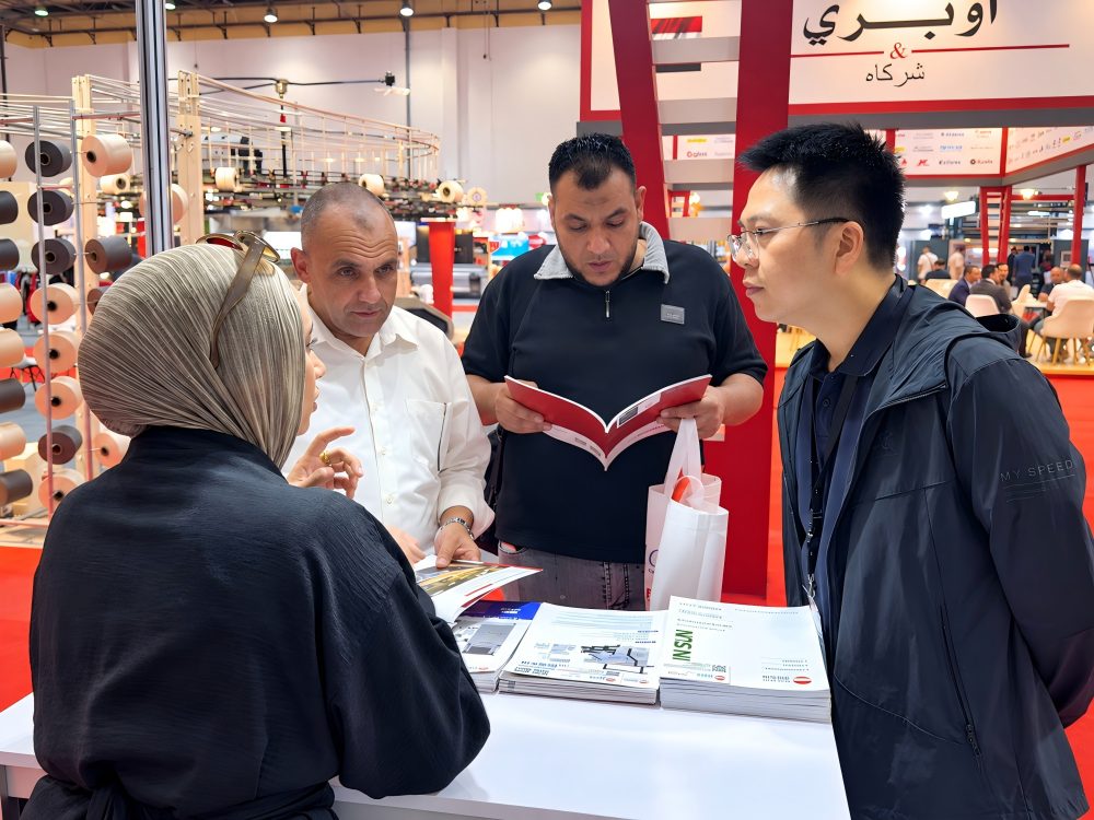 Customer Consultation at Egypt Stitch & Tex 2026 Visitors reviewing textile machinery information with Shin Tong Yunn at Egypt Stitch & Tex 2026